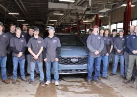Students, faculty and Fox Marquette staff surround the donated 2023 Ford Escape