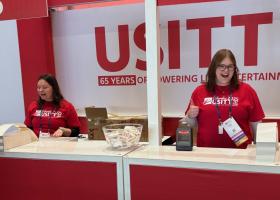 Molly Sobiechowski and Ashley Reinhart working the registration booth as conference assistants.