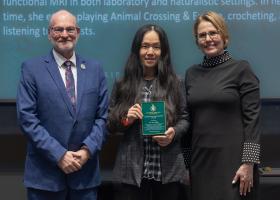 Assistant Professor Lin Fang (center) with Liz Wuorinen, dean of the College of Health Sciences and Professional Studies (left) and Provost Anne Dahlman