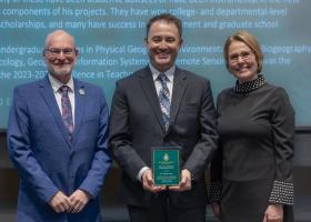 Assistant Professor Adam Naito (center) with Robb Winn, dean of Arts and Sciences, and Provost Anne Dahlman