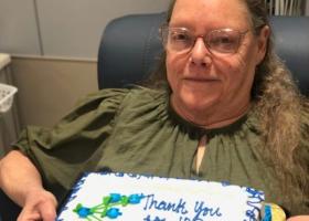 Grace Albert with the cake marking her 100th blood donation (U.P. Regional Blood Center photo)