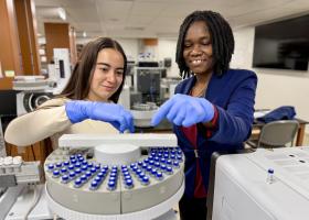 Student Sabrina Mata and visiting AAUW research fellow Justine Nakintu in the NMU Chemistry lab.