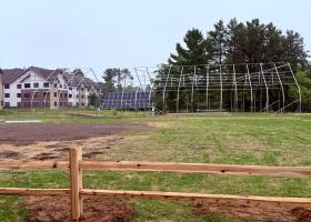 A portion of the Woodland Park site, with the relocated solar array (formerly near the athletic complex) in the back, and the frame for the Hoop House (formerly outside Jacobetti).