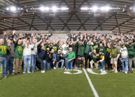 The 1975 team members hold up four fingers as a tribute to the late coach Buck Nystrom's fourth-quarter program when they were honored during halftime of the Wildcats Oct. 11 game in the Superior Dome.