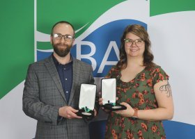 Kyle Schaeffer and Marie Johnson with their 2026 Outstanding Staff awards.
