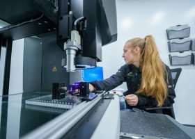 Mount Mfg Production Technician Team Lead Sara Sands operates a CMM machine.