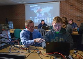 NMU stock photo of Professor Jim Marquardson with a student.