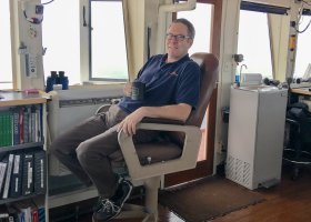 Hughes relaxing in the captain's seat