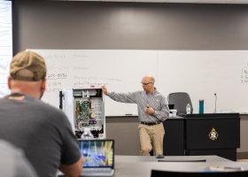 Glen Breaux, Senior Area Service Manager from Mitsubishi Electric, provides training to NMU HVAC/R students and faculty.
