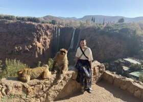 Hamel seated in front of the Ouzoud Waterfalls in Morocco.