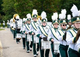 NMU's marching band performs during 2025's Homecoming Tailgate party.