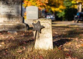 The gravestone of Civil War veteran Capt. E. W. Fiske. Fiske's marker, along with 12 other markers of Civil War veterans, were cleaned by volunteers from NMU.