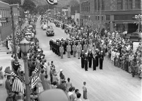 A 1955 parade moves through downtown Munising. Photo courtesy of Superior View Archive.
