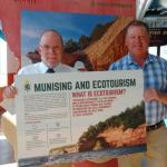 Image of President Fritz Erickson delivering ecotourism display piece to NMU alumnus John Madigan