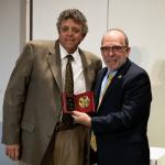 Tom Fish (left) accepting his award from NMU President Fritz Erickson