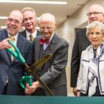June Jamrich (far right) watches as NMU President Fritz Erickson and former President John X. Jamrich cut the ribbon for the new Jamrich Hall dedication in 2014.