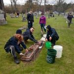 Volunteers cleaning tombstones