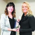 Daust (right) receiving the award from Evergreen Committee Chair Kori Bjorne