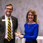 Dr. Ellen Narotzky Kennedy accepts the Distinguished Alumni Award from NMU President Brock Tessman