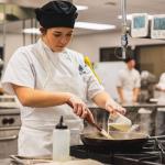 Hospitality Leadership student preparing food (NMU stock photo)