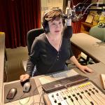 Nicole Walton behind the microphone in the Public Radio 90 studio.