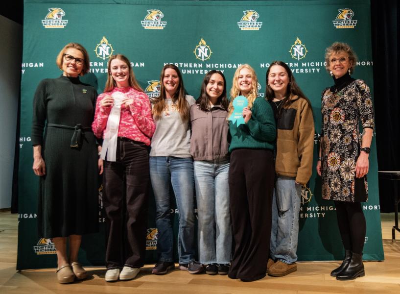 Third place group division (from left): Provost Anne Dahlman, Megan Wells, Faculty Adviser Amber LaCrosse, Lily Briggs, Isabella Enger, Jayme Pomper, and Dean Lisa Schade Eckert.